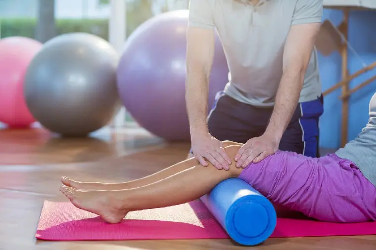 A person is using a foam roller to stretch.