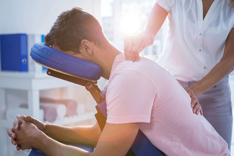 A man is getting his neck examined by an osteopath.