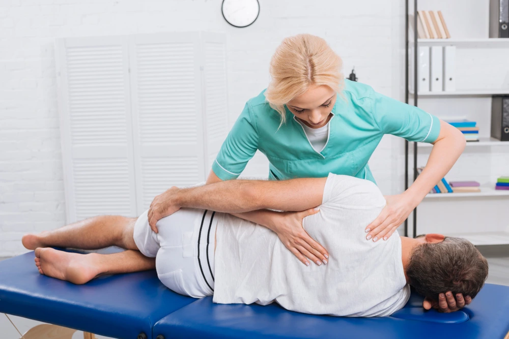 Auto accident chiropractor providing chiropractic spinal adjustment therapy after injury.
