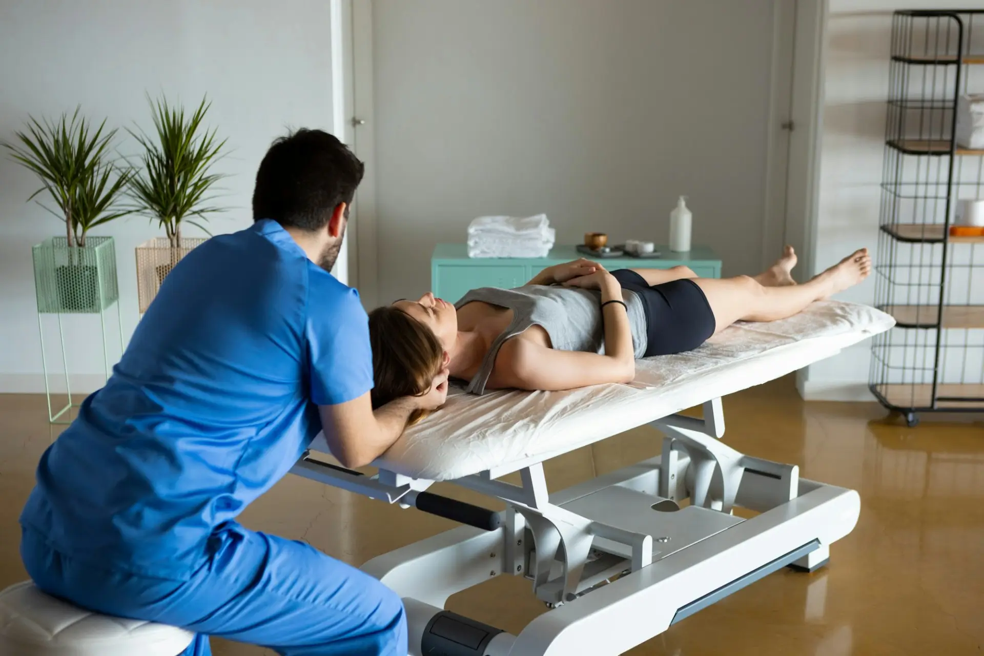 A chiropractor performing a gentle cervical spine assessment on a patient at Dickinson Chiropractic to help provide natural migraine relief for Henderson residents.